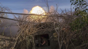 Ukrainian serviceman of 56th brigade fire by self-propelled artillery towards Russian positions at the frontline on Chasiv Yar direction, Donetsk region, Ukraine, Sept. 27, 2024. (AP Photo/Evgeniy Maloletka)