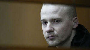 Alexander Permyakov, a Ukrainian national standing trial over a car bombing that injured well-known nationalist novelist and ardent Kremlin supporter Zakhar Prilepin, sits in a glass cage in a courtroom prior to a session in the Russian Military Court in Moscow, Russia, Monday, Sept. 30, 2024. (AP Photo/Alexander Zemlianichenko)