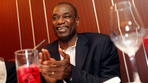 In this Wednesday, June 13, 2012 photo, former NBA star Dikembe Mutombo smiles during his meeting with sports journalists at a restaurant in Tokyo.  (AP Photo/Junji Kurokawa)