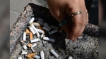 Three tobacco giants are again seeking to extend an order suspending legal proceedings against them as they continue to negotiate a settlement with creditors in a process that has stretched more than five years. A smoker puts out a cigarette in an ashtray in Ottawa on May 31, 2016. THE CANADIAN PRESS/Sean Kilpatrick