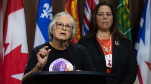 The Survivors' Secretariat Executive Lead Laura Arndt, right, looks on as survivor of the Mohawk Institute and Secretariat board member Roberta Hill speaks during a news conference on Parliament Hill, in Ottawa, Monday, Sept. 30, 2024. THE CANADIAN PRESS/Adrian Wyld