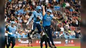 Toronto Argonauts wide receiver Dejon Brissett (18), left, and offensive lineman Ryan Hunter (62) celebrate following Brissett's touchdown against the Hamilton Tiger-Cats during CFL action in Toronto, on Saturday, Sept. 23, 2023. Argonauts head coach Ryan Dinwiddie appears to have found a new starting left tackle. Canadian Hunter made the move from left guard to tackle for Toronto's 37-31 home win over the Montreal Alouettes on Saturday night.THE CANADIAN PRESS/Spencer Colby