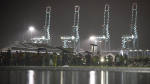 Hundreds of longshoremen strike together outside of the Virginia International Gateway in Portsmouth, Va., Tuesday, Oct. 1, 2024. (Billy Schuerman/The Virginian-Pilot via AP)