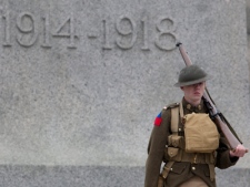 A member of the honour guard dressed in period uniform stands infront of the National War Memorial during the End of an Era ceremony in Ottawa, Friday April 9, 2010.