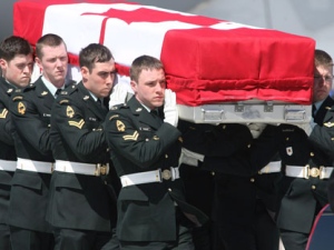 The casket of Pte. Tyler William Todd from the 1st Battalion, Princess Patricia's Canadian Light Infantry, based in Edmonton, Alberta, is carried from a military aircraft during a repatriation ceremony at CFB Trenton on Wednesday, April 14 2010. (THE CANADIAN PRESS/Peter Redman)