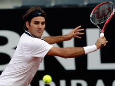 Switzerland's Roger Federer returns the ball during a double game he played with Switzerland's Yves Allegro against Sweden's Johan Brunstrom and Netherlands Antilles' Jean-Julien Rojer, at the Rome Masters tennis tournament, in Rome, Monday, April 26, 2010. (AP Photo/Andrew Medichini)