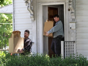 Law enforcement investigators carry boxes containing bags labeled "evidence" as they depart a home at 39 Waverley Avenue, in Watertown, Mass., Thursday, May 13, 2010. (AP Photo/Steven Senne)