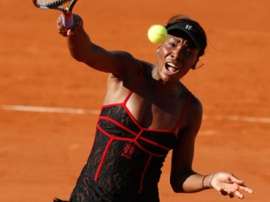 USA's Venus  Williams returns the ball to Switzerland's Patty Schnyder during their first round match of the French Open tennis tournament at the Roland Garros stadium in Paris, Sunday, May 23, 2010. (AP Photo/Michel Spingler)