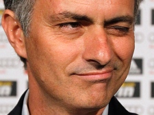 Real Madrid's new coach Jose Mourinho winks during a news conference at the Santiago Bernabeu stadium in Madrid on Monday, May 31, 2010. Mourinho said at his official presentation Monday that the Spanish team needs to add three or four new players this offseason, although he did not specify which. (AP Photo/Victor R. Caivano)