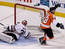 Philadelphia Flyers right wing Claude Giroux (28) celebrates after scoring the game-winning goal against Chicago Blackhawks goalie Antti Niemi (31), of Finland, in the overtime period of Game 3 of the NHL Stanley Cup hockey finals on Wednesday, June 2, 2010, in Philadelphia. The Flyers won 4-3. The Blackhawks lead the series 2-1. (AP Photo/Kathy Willens)