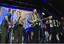 Arcade Fire guitarists Richard Parry, left, Will Bulter, second left, and lead singer Win Butler, third left, perform at the Ukrainian Federation headquarters in Montreal, Que., Tuesday, Feb. 6, 2007. (CP / Ryan Remiorz)