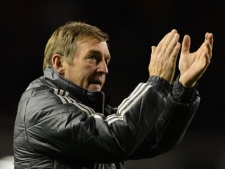 Liverpool's manager Kenny Dalglish applauds supporters after his team's 4-1 wi over Chelsea in their English Premier League soccer match at Anfield Stadium, Liverpool, England, on Tuesday, May 8, 2012. (AP Photo/Jon Super)