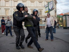 Police detain an opposition member, who refused to leave the park around Chistiye Prudy, or Clear Ponds, in Moscow early Wednesday, May 16, 2012. (AP Photo/Alexei Nikolayev)