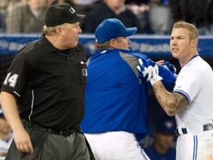 Toronto Blue Jays Manager John Farrell restrains Brett Lawrie (right) as he confronts Home Plate Umpire Bill Miller (left) ) as the third baseman contests a strike out call during the ninth inning of MLB baseball action against Tampa Bay Rays in Toronto on Tuesday May 15 , 2012. THE CANADIAN PRESS/Chris Young