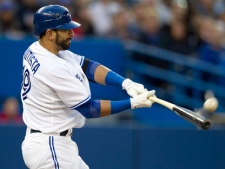 Toronto Blue Jays Jose Bautista hits a solo homer off New York Yankees starting pitcher Phil Hughes during thrid inning AL action in Toronto on Thursday, May 17, 2012. (THE CANADIAN PRESS/Frank Gunn)