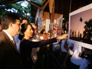 Myanmar opposition leader Aung San Suu Kyi, center, is seen during the opening ceremony of a photo exhibition at the Institut Francaise in Yangon, Myanmar, on Thursday, May 17, 2012. (AP Photo/Khin Maung Win)