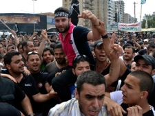 Anti-Syrian regime critic Shadi Mawlawi, centre, who was accused of belonging to a terrorist group, is carried on his friends' shoulders as they celebrate his release from jail in the northern port city of Tripoli, Lebanon, Tuesday May 22, 2012. (AP Photo)