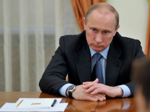 Russian President Vladimir Putin listens during a meeting with United Russia party members in Novo-Ogaryovo residence outside Moscow on Wednesday, May 23, 2012. Putin signalled his support for a controversial bill that would increase fines 200-fold for those taking part in unsanctioned protests. (AP Photo/RIA Novosti, Alexei Nikolsky, Government Press Service)