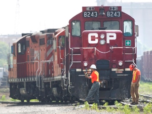 Surveyors work next to CP Rail trains parked on train tracks in Toronto on Wednesday, May 23, 2012. (THE CANADIAN PRESS/Nathan Denette)