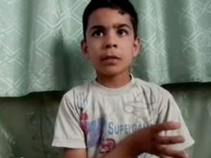 This image made from amateur video, released by the Houla Media Office and accessed Thursday, May 31, 2012 purports to show 11-year-old Ali el-Sayed, a survivor of the Houla massacre that began Friday and left 108 people dead, many of them children and women. Ali is one of the few survivors of the weekend massacre in Houla, a collection of poor farming villages and olive groves in Syria's central Homs province. More than 100 people were killed, many of them women and children who were shot or stabbed in their houses. (AP Photo/Shaam News Network via AP video) 