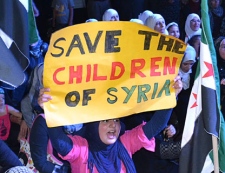 An Anti-Syrian regime protester holds up a placard as she shouts slogans during a demonstration against the Houla massacre, held by the Syrian opposition citizens who live in Lebanon, in the northern port city of Tripoli, Friday, June 1, 2012. Saying he is "impatient and frustrated," special envoy Kofi Annan called on the Syrian president Friday to implement a U.N.-brokered peace plan following a horrific weekend massacre that killed more than 100 people. (AP Photo)