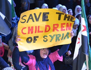 An Anti-Syrian regime protester holds up a placard as she shouts slogans during a demonstration against the Houla massacre, held by the Syrian opposition citizens who live in Lebanon, in the northern port city of Tripoli, Friday, June 1, 2012. Saying he is "impatient and frustrated," special envoy Kofi Annan called on the Syrian president Friday to implement a U.N.-brokered peace plan following a horrific weekend massacre that killed more than 100 people. (AP Photo)