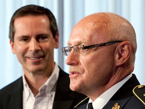 Ontario Premier Dalton McGuinty (left) listens as newly appointed OPP Commissioner Chris Lewis speaks during a news conference at the Ontario Legislature in Toronto on Wednesday July 7, 2010. (THE CANADIAN PRESS/Frank Gunn)