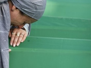 A Bosnian Muslim woman weeps near the coffin of her relative, a victim of the 1995 Srebrenica massacre, in Potocari 120 km northeast of Sarajevo, Bosnia, on Sunday, July 11, 2010. (Amel Emric/AP Photo) 