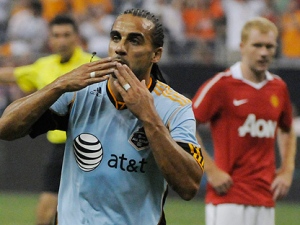 Major League Soccer All-Stars' Dwayne De Rosario, of Toronto FC, blows a kiss after scoring a goal in the second half of the game against Manchester United on Wednesday, July 28, 2010 in Houston. Manchester United won 5-2. (AP Photo/Pat Sullivan)