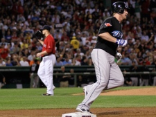 Toronto Blue Jays Lyle Overbay, right, rounds first base on his second three-run home run off Boston Red Sox starter Jon Lester, left, during the third inning of their baseball game at Fenway Park in Boston, Friday Aug. 20, 2010. (AP Photo/Charles Krupa)