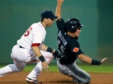 Boston Red Sox's Marco Scutaro, left, catches Toronto Blue Jays' Travis Snider between bases on a single by Fred Lewis in the tenth inning of a baseball game in Boston, Saturday, Aug. 21, 2010. (AP Photo/Michael Dwyer)