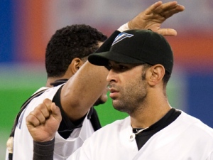 Toronto Blue Jays Jose Bautista  (front) gets a pat on the head from catcher Jose Molina after the Jays defeated the New York Yankees 3-2 in AL action in Toronto on Monday August 23, 2010. 