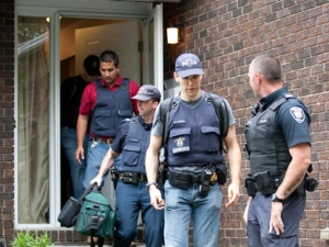 Police leave a house in the west end of Ottawa, Wednesday August 25, 2010. The RCMP have arrested two Ottawa residents in relation to terrorist offences following a raid on a west-end Ottawa home early Wednesday. (THE CANADIAN PRESS/Adrian Wyld)