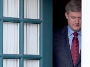 Prime Minister Stephen Harper steps out of his home at 24 Sussex Dr in Ottawa Friday March 19, 2010. THE CANADIAN PRESS/Adrian Wyld