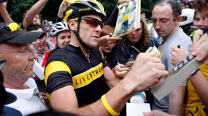 Lance Armstrong signs autographs for fans