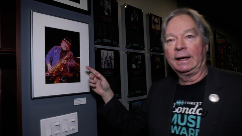 Music historian James Reaney points to a framed photo of the late Garth Hudson at the London Music Hall of Fame, Jan. 21, 2025